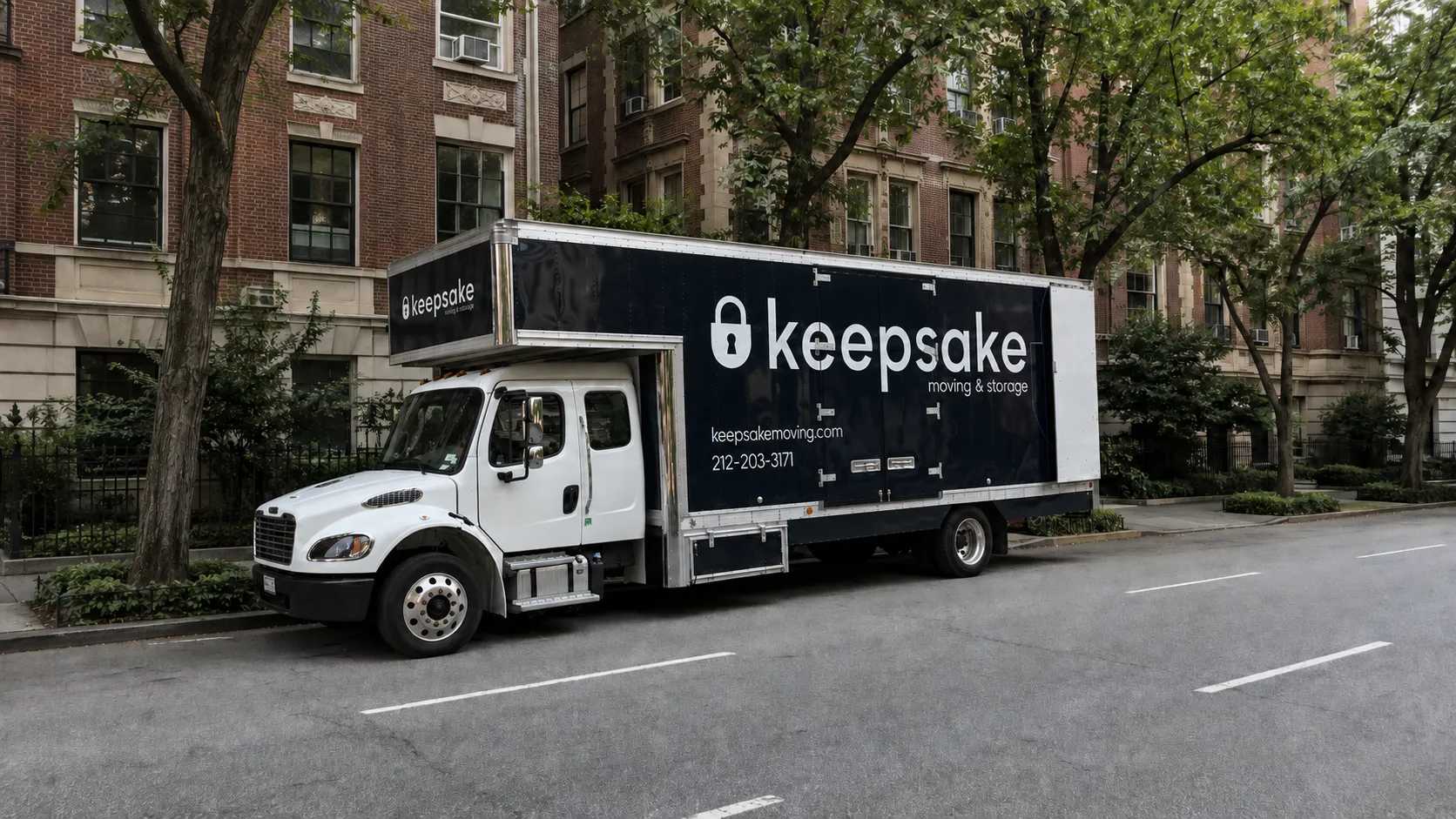 A larger Keepsake truck parked on a tree-lined residential street.
