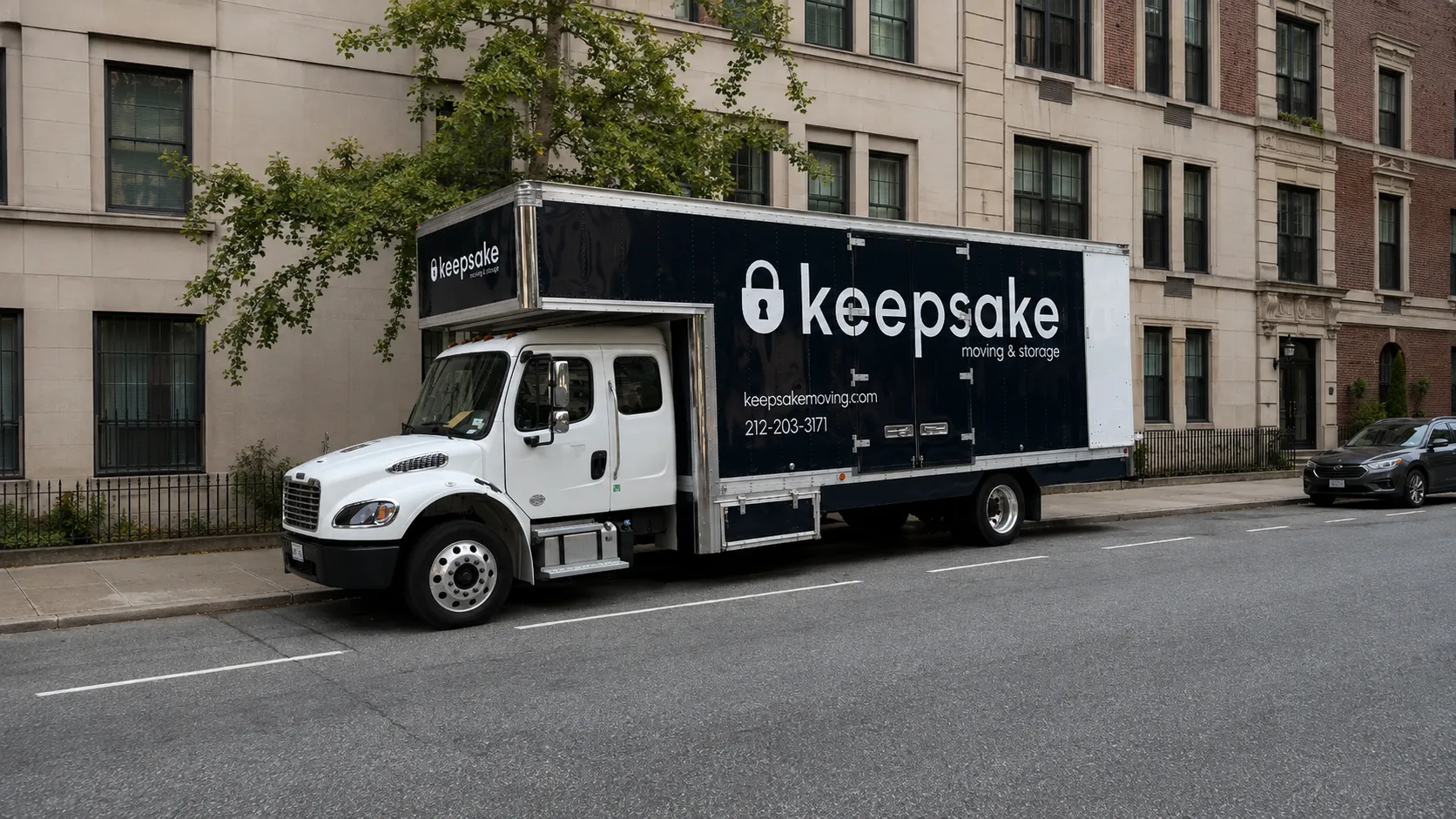 A larger Keepsake truck parked with clear space along a residential curb.